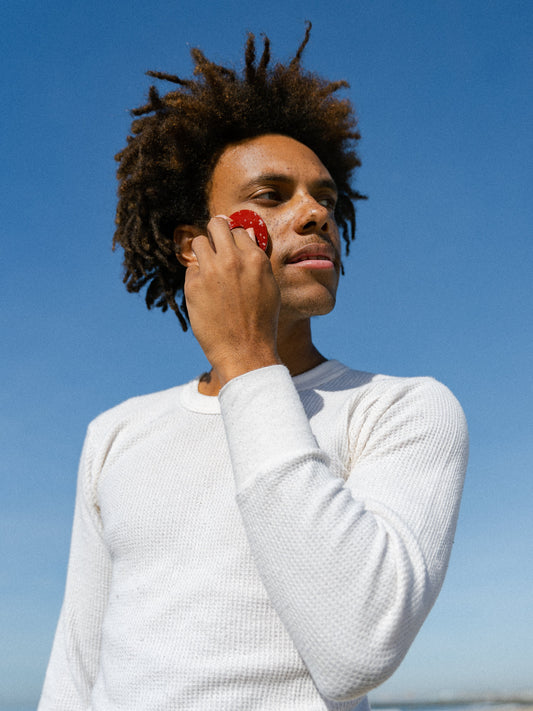Man using Boie's face scrubber to cleanse and reduce the look of acne
