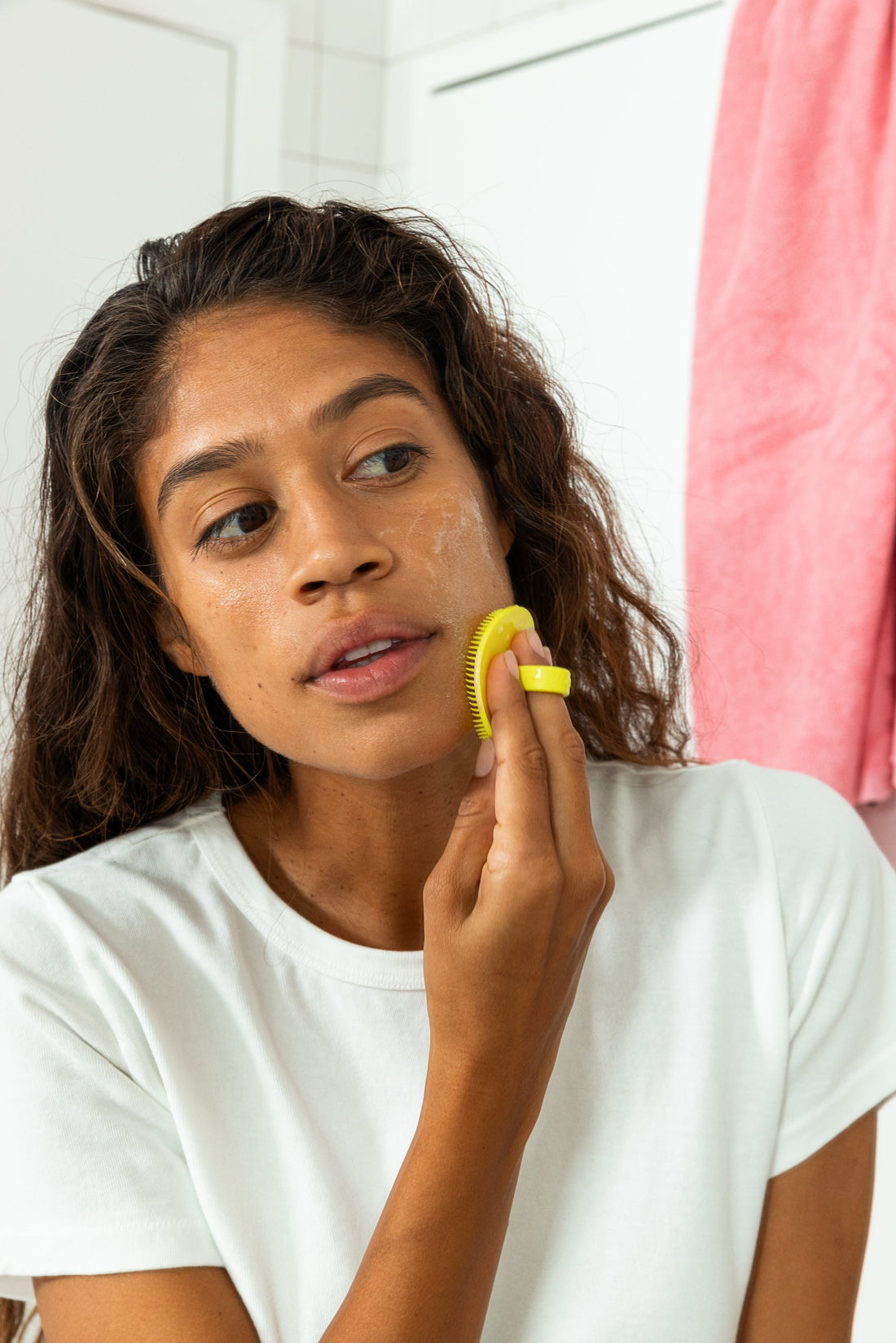 Woman cleansing her face with Boie's gentle facial exfoliating face scrubber