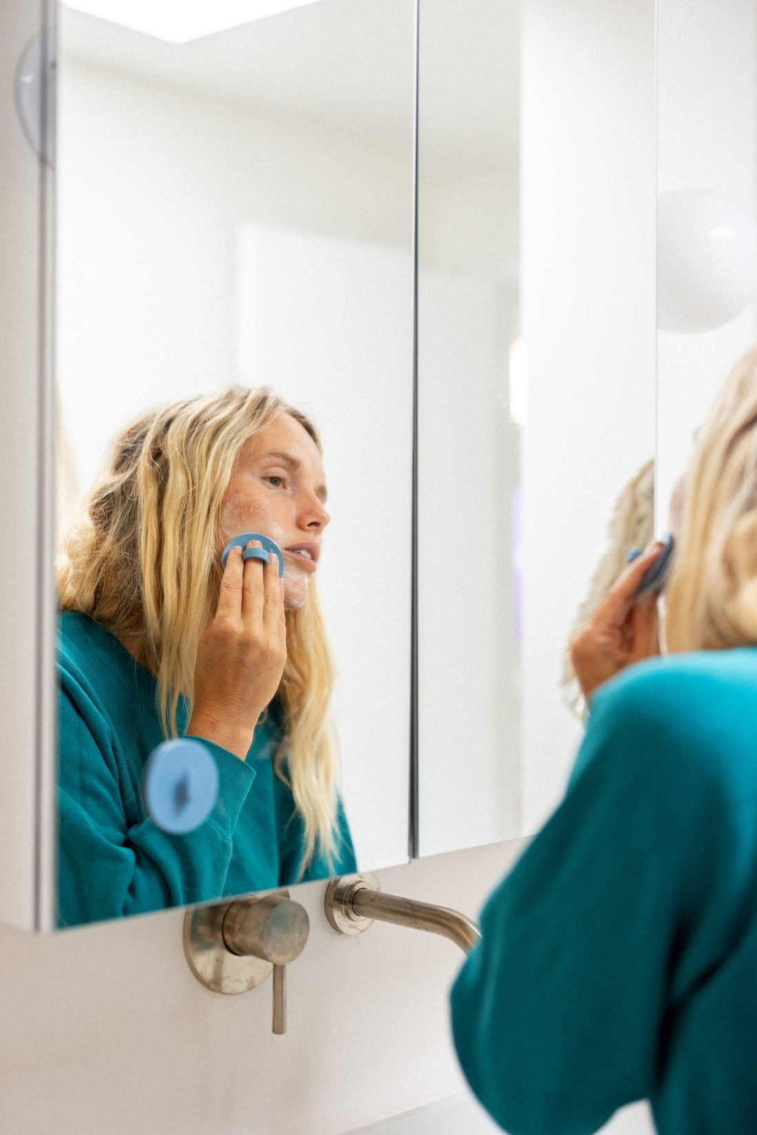 Woman gently exfoliating and cleansing her face with Boie's facial cleansing scrubber