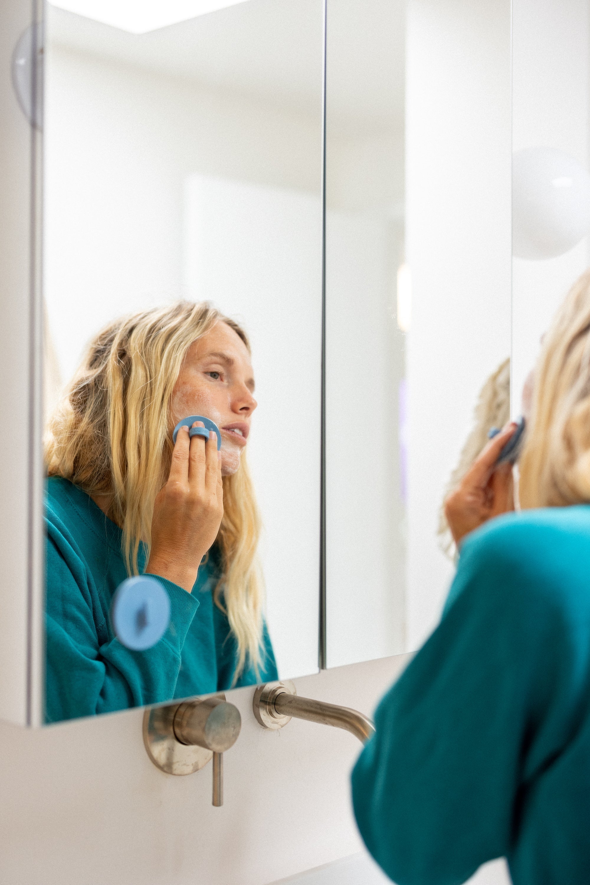 Woman gently exfoliating and cleansing her face with Boie's facial cleansing scrubber